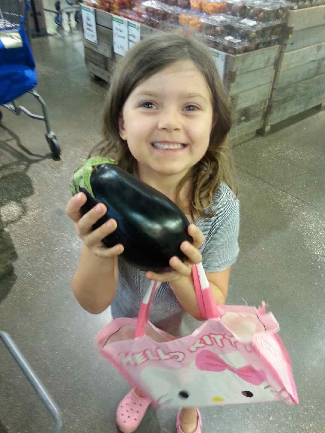 Zoey holding an eggplant